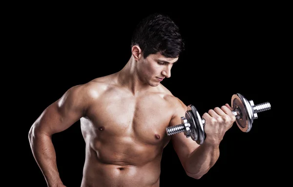 Portrait of a strong man lifting weights against a dark backgrou — Stock Photo, Image