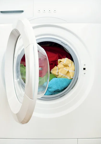 Washing machine with dirty clothes inside, studio shot — Stock Photo, Image