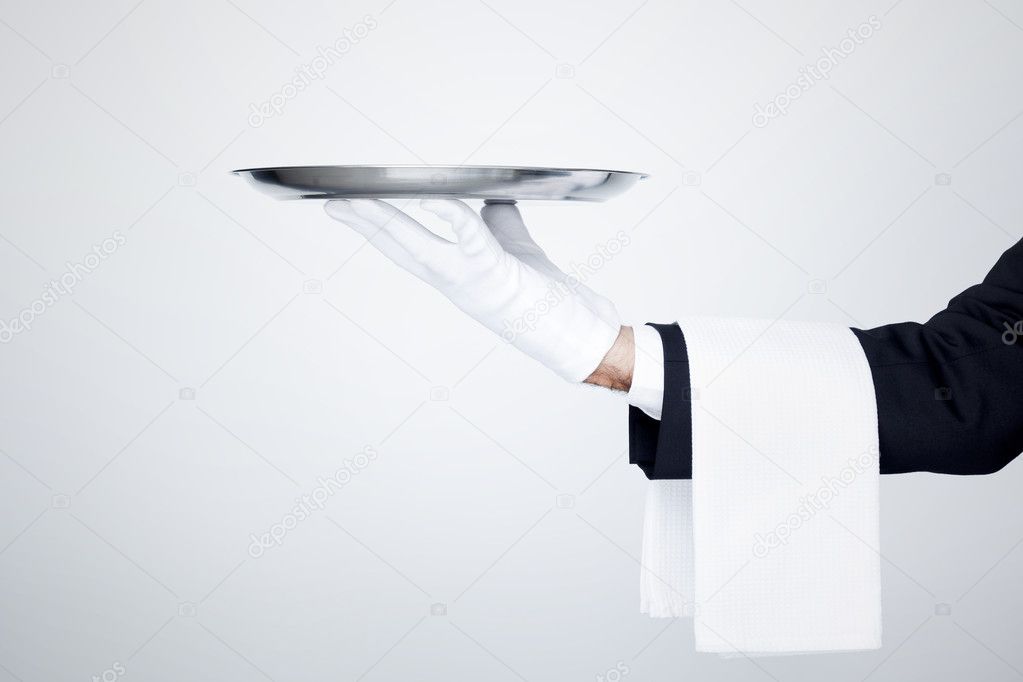 Professional waiter holding an empty silver tray