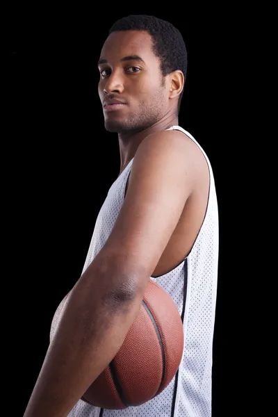 Basketball player with ball against dark background — Stock Photo, Image