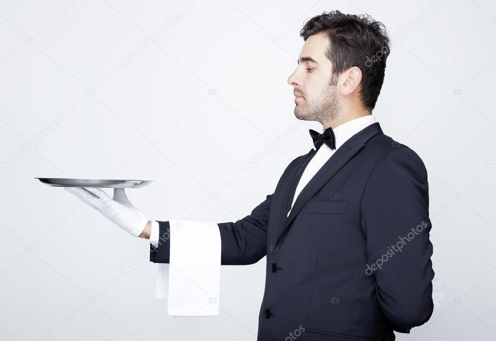 Professional waiter holding empty silver tray