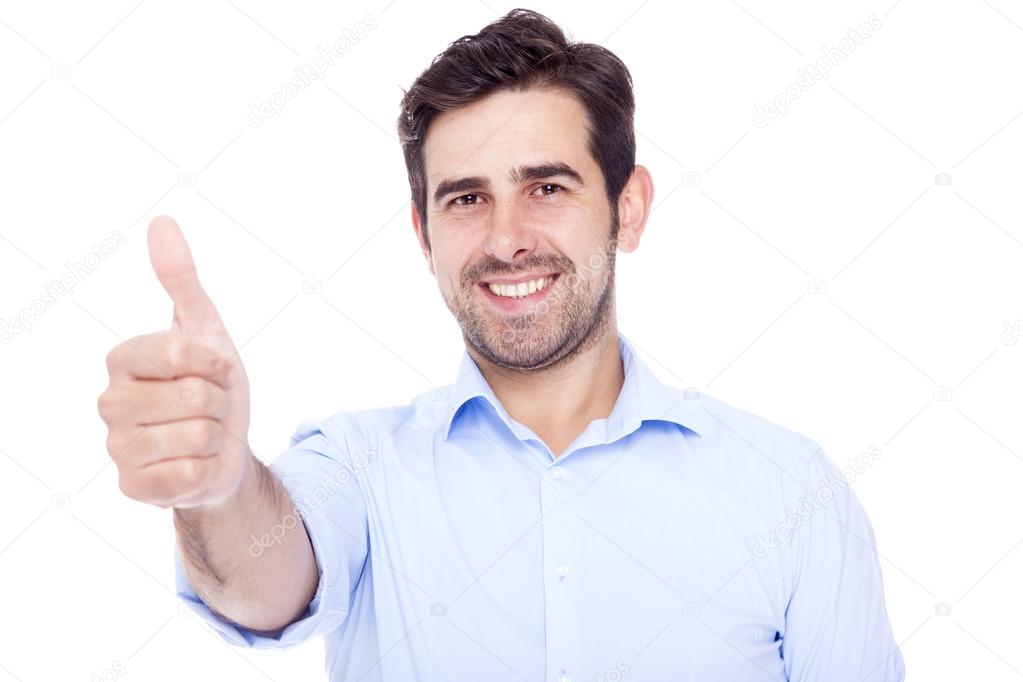 Handsome latin man thumbs up over a white background