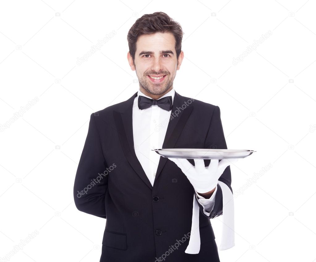 Handsome waiter holding an empty silver tray, isolated on white