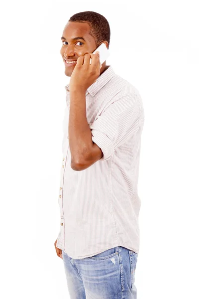 Smiling young man talking on mobile phone — Stock Photo, Image
