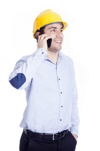 Handsome engineer talking with a smartphone, isolated on white
