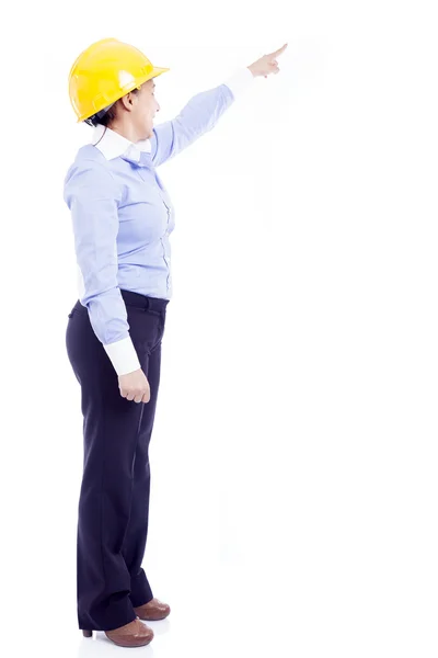 Жінка-інженер, що вказує на копійку, ізольована на білому — стокове фото