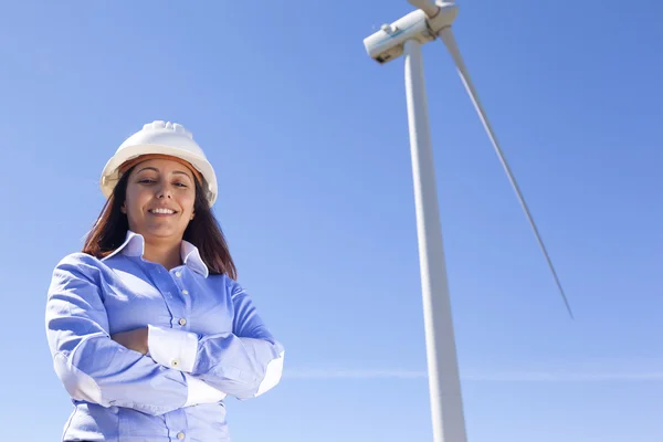 Beautiful engineer standing at wind farm — Stock Photo, Image