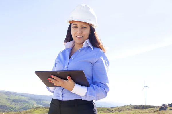 Female engineer working with a tablet at wind farm — Stock Photo, Image
