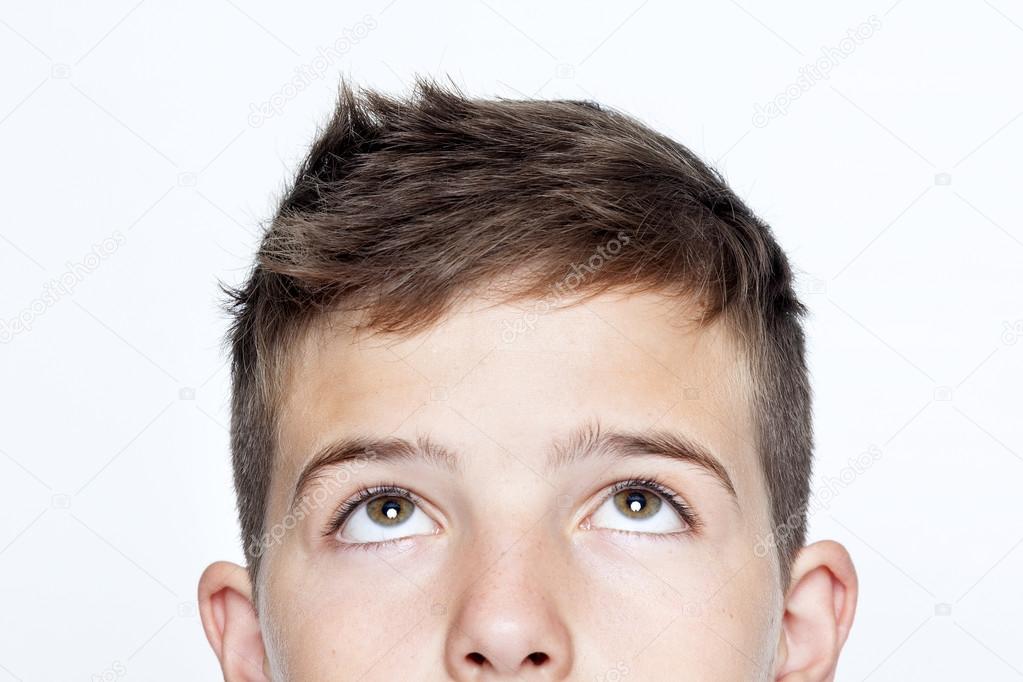 Close up portrait of boy looking up