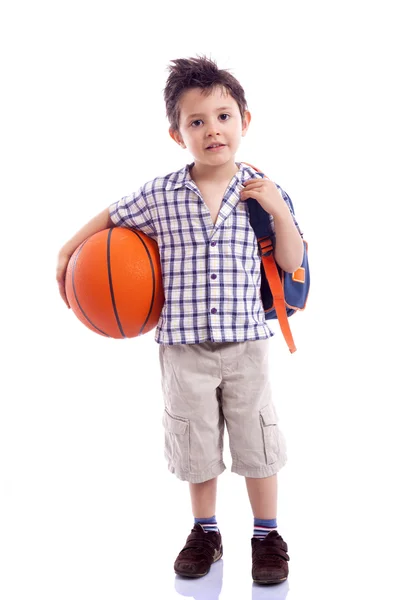 Happy school kid holding a basket ball, isolated on white backgr — Stock Photo, Image
