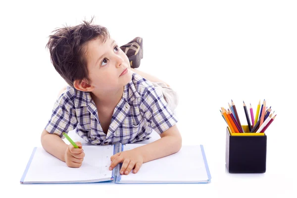 Schoolboy drawing with colored pencils, isolated on white backgr Stock Image