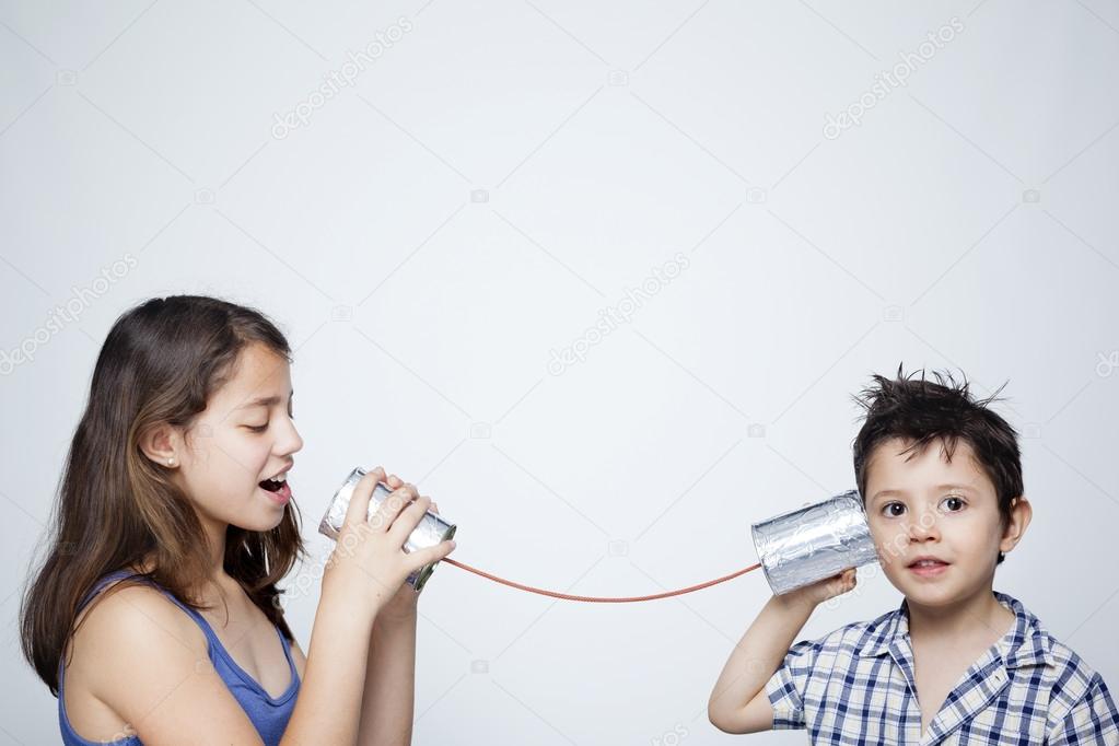 Kids using can as telephone