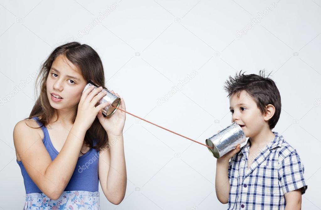 Kids using a can as telephone