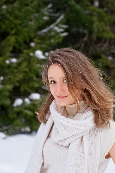 Lächelnde kaukasische junge Frau posiert im verschneiten Winter — Stockfoto