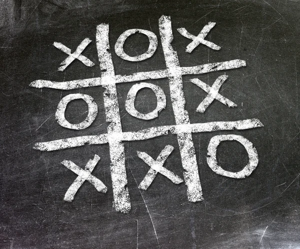 Noughts and crosses drawn on a chalkboard — Stock Photo, Image