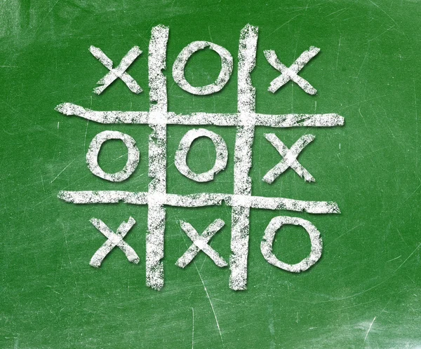 Noughts and crosses drawn on a chalkboard — Stock Photo, Image