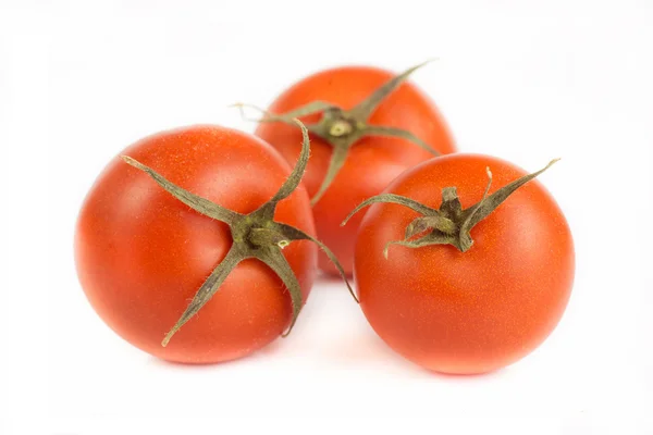 Tomates com folhas verdes isoladas sobre fundo branco — Fotografia de Stock