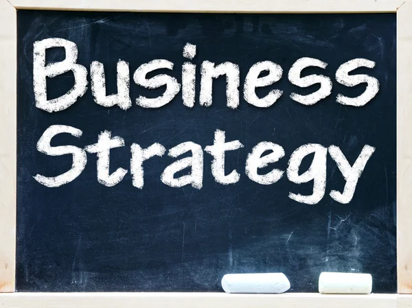 Business strategy handwritten with white chalk on a blackboard. — Stock Photo, Image