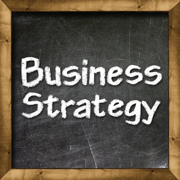 Business strategy handwritten with white chalk on a blackboard. — Stock Photo, Image