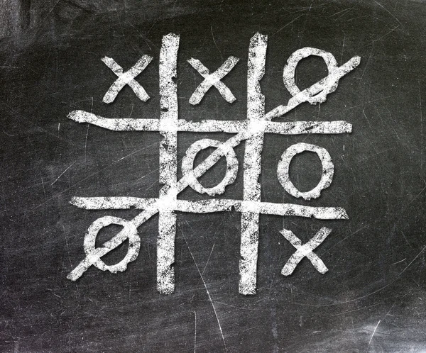 Noughts and crosses drawn by hand on a chalkboard — Stock Photo, Image