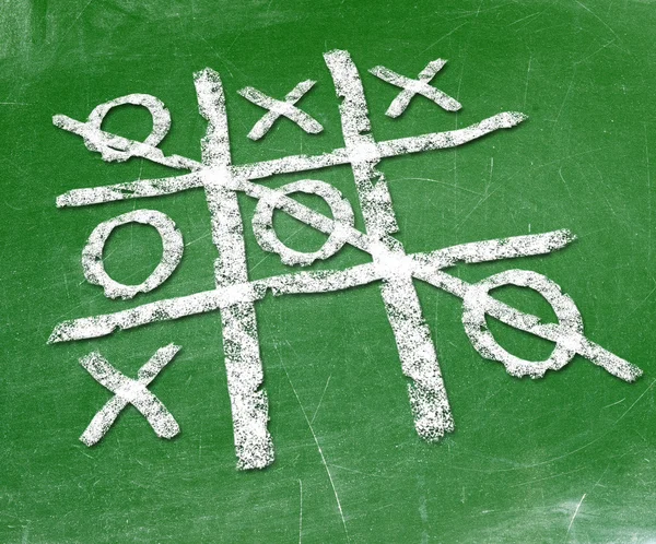 Noughts and crosses drawn by hand on a chalkboard — Stock Photo, Image