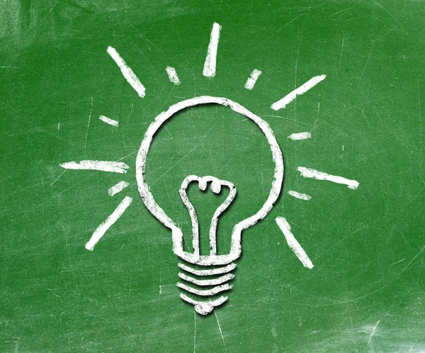 Light bulb on blackboard background — Stock Photo, Image