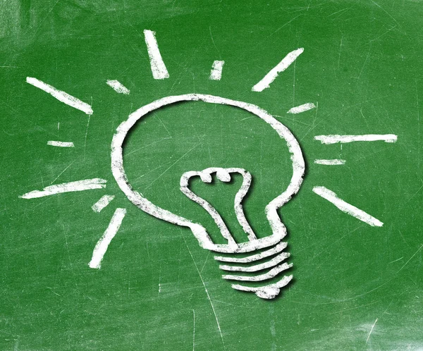 Light bulb on blackboard background — Stock Photo, Image