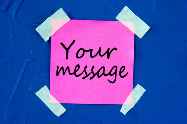 Your message, written on pink sticky paper sticked on blue wall — Stock Photo, Image