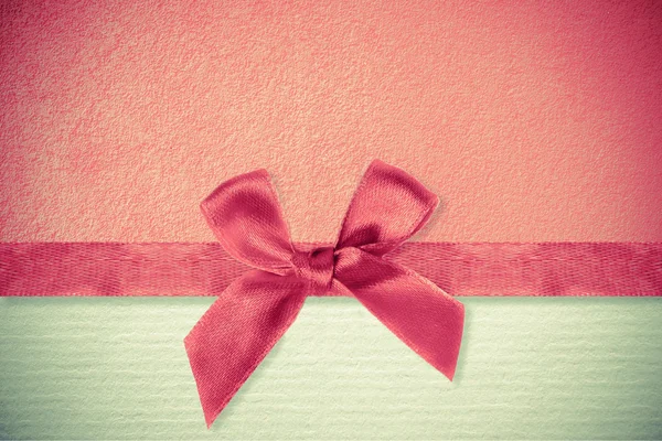 Ribbon and bow on a paper background — Stock Photo, Image