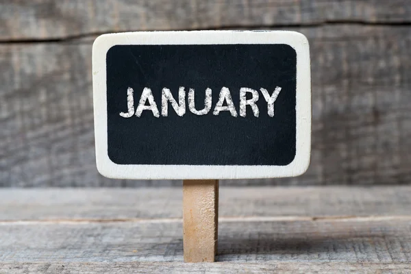 Januari op kleine houten frame schoolbord — Stockfoto