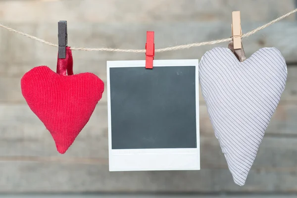 Blank instant photo and heart hanging on the clothesline — Stock Photo, Image