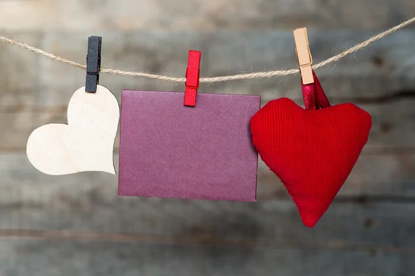 Blank instant paper sheet and heart hanging on the clothesline — Stock Photo, Image