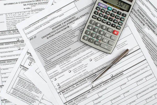 A calculator, pen, and financial statement — Stock Photo, Image