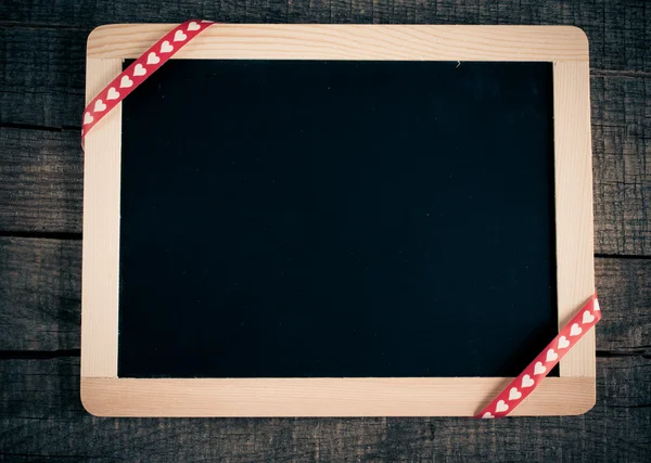 Small blackboard hanging on wooden