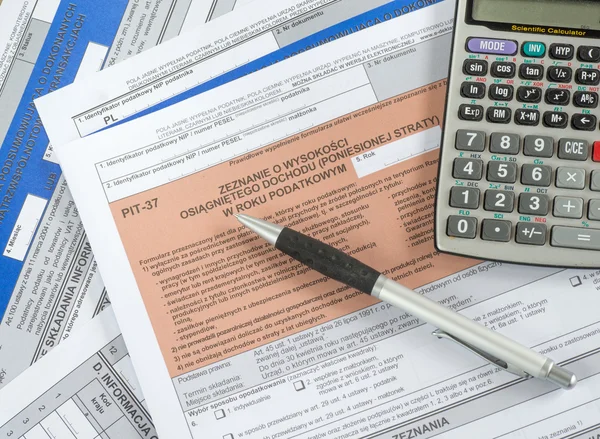 Modern calculator, black pen and tax forms — Stock Photo, Image