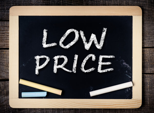 Low price handwritten with white chalk on a blackboard