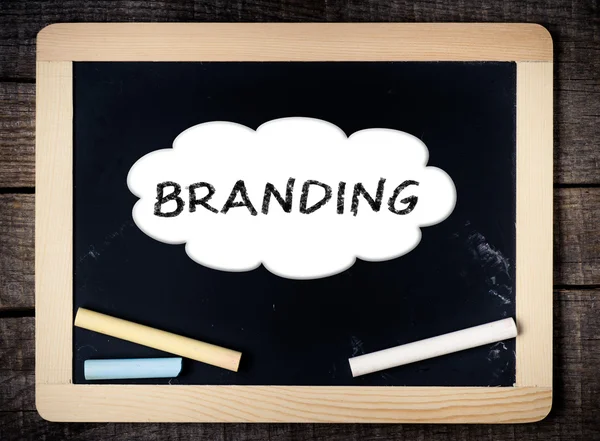 Branding handwritten with white chalk on a blackboard — Stock Photo, Image