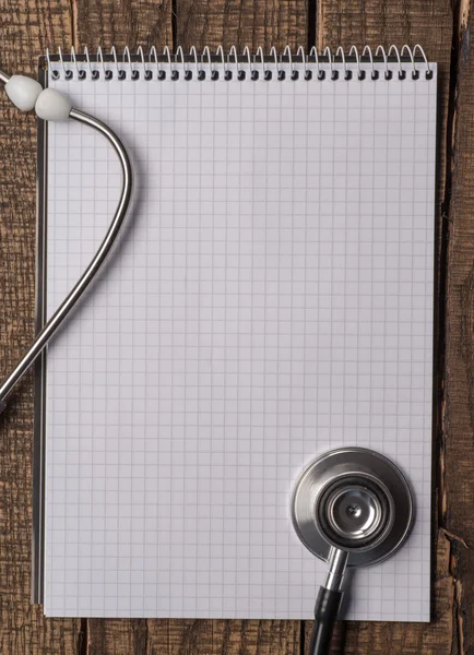 A blank and stethoscope on a desktop — Stock Photo, Image