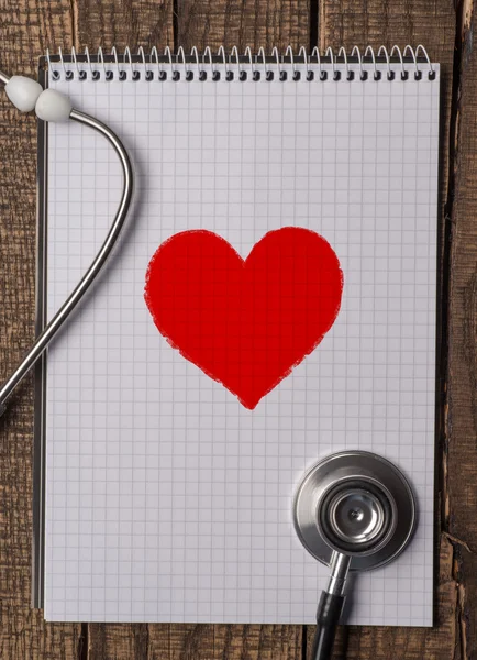 Wood texture background with stethoscope and heart symbol — Stock Photo, Image