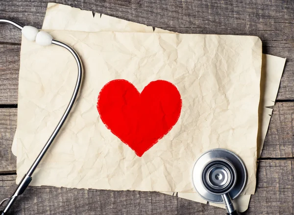 Wood texture background with stethoscope and heart symbol — Stock Photo, Image