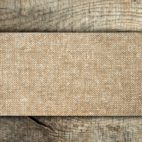 Burlap texture on wooden table — Stock Photo, Image