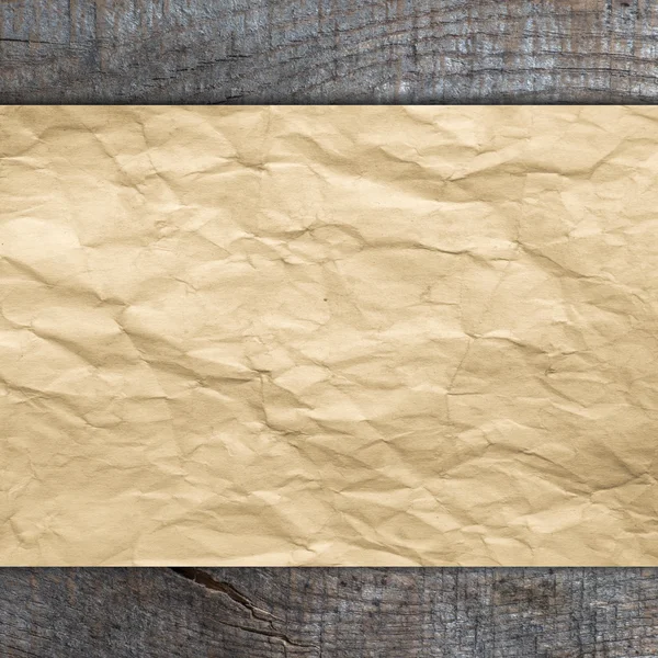 Old paper on wooden background — Stock Photo, Image