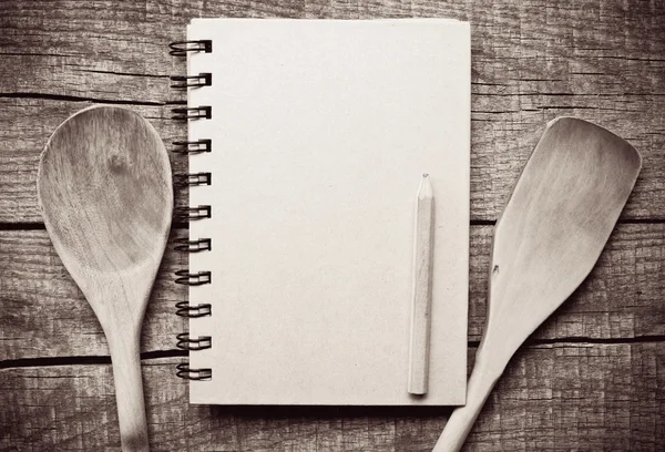 Old paper and wooden spoon — Stock Photo, Image