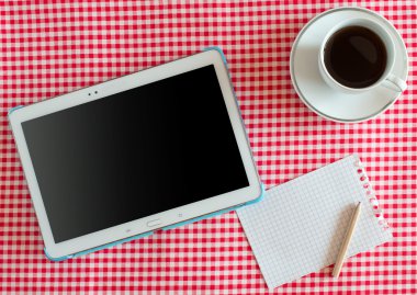 Empty tablet pc and a coffee and notebook with pen clipart