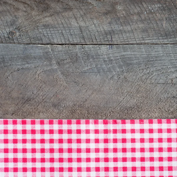 Old wooden board with checkered cloth — Stock Photo, Image