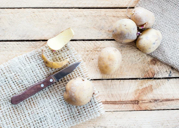 Potatoes and knife — Stock Photo, Image