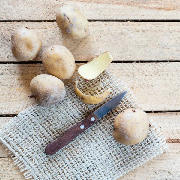 Potatoes and knife — Stock Photo, Image