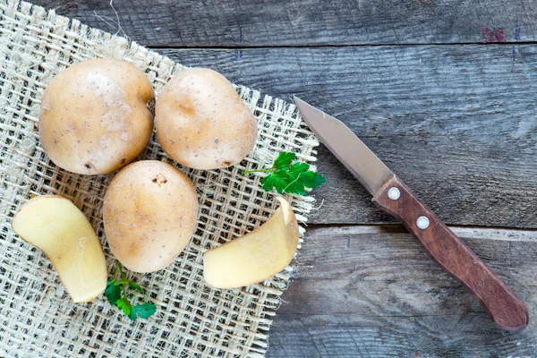 Potatoes and knife — Stock Photo, Image