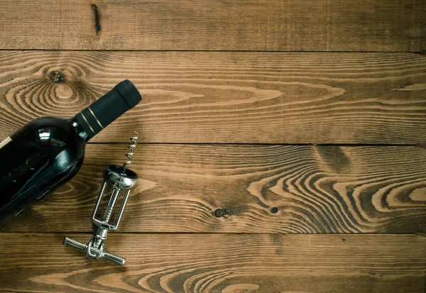 Red wine bottle with cork screw — Stock Photo, Image