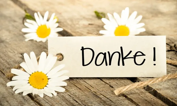 Bloemen en label met letters van dank — Stockfoto